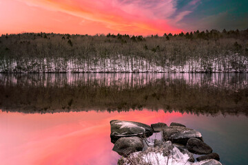 The vibrant winter landscape of Webb Mountain and water reflection on Lake Zoar in Monroe,...