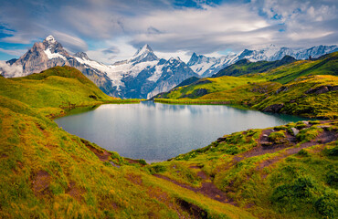 Majestic autumn view of snowy Schreckhorn peak. Calm morning landscape of  of Bachalpsee lake....