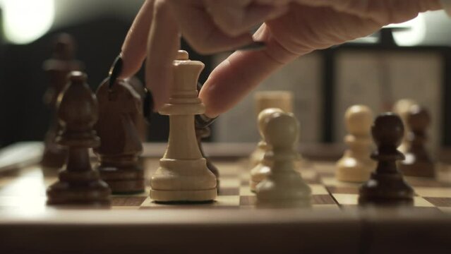 Panoramic movement in chessgame, female hand moves queen from C2 to C6, cinematic lights and shallow depth of field