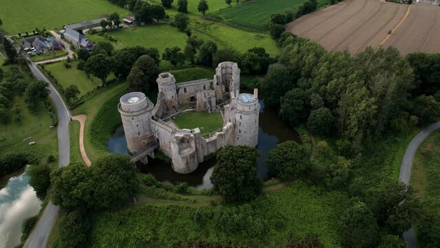 drone shot around Hunaudaye Castle in Brittany, France during summer on an overcast day