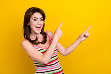 Photo of good mood positive girl dressed striped top indicating at discount empty space isolated on...