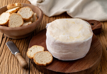 Fototapeta na wymiar Jordao cheese, brazilian country cream cheese with toasts over wooden table