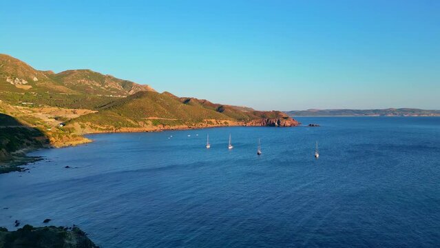 Scenic drone view of sailing boats at Porto Flavia Masua beach, South Sardinia, Italy