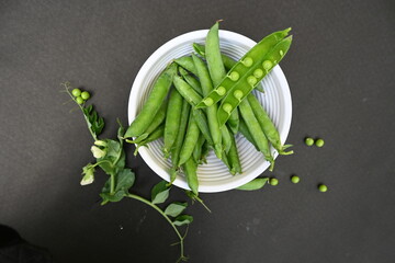 Fresh Green peas on black background. There is a lot of vitamins  and Minerals in it. The pea is...