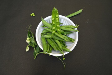 Fresh Green peas on black background. There is a lot of vitamins  and Minerals in it. The pea is...
