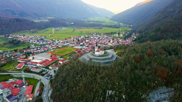 Aerial 4K drone footage captures the majestic Church of Saint Anthony, Kobarid- Slovenia. This landmark is dedicated to the memory of the fallen soldiers from World War I. Filmed in late autumn.
