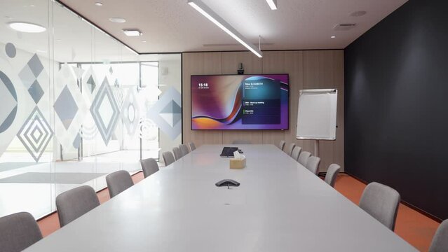 Slow establishing shot of a large empty conference table ready for a meeting