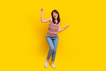 Fototapeta na wymiar Full size photo of lovely woman dressed knitwear top jeans pants in sunglass dancing look empty space isolated on yellow color background