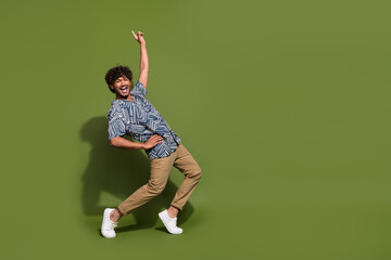 Full body size photo of funny crazy cool mexican guy pointing finger up seems like famous dancer star isolated on khaki color background - obrazy, fototapety, plakaty