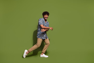 Full body length photo of young american guy in trendy garment loves cheap clothes with high comfort isolated on khaki color background