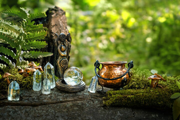 witch cauldron, wiccan Goddess ritual figurine and quartz crystals in forest, natural background....