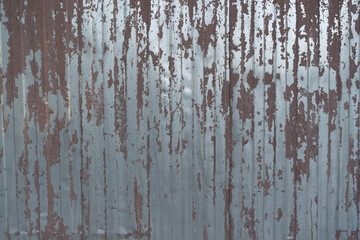 texture of brown painted corrugated metal old wall outside paint cracked