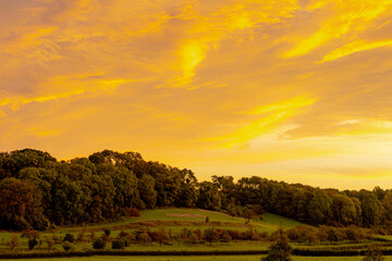 The terrain hilly countryside with golden skyline in the morning during sunrise in summer, Noorbeek is a village in the Dutch province of Limburg, The municipality of Eijsden-Margraten, Netherlands.