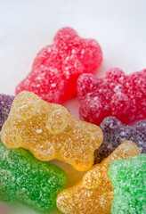 Sugar covered jelly teddies with selective focus on white with copy space