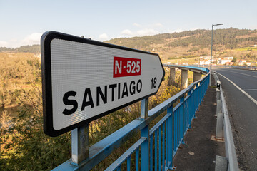 A Ponte Ulla, Spain. Road sign indicating directions to Santiago de Compostela and kilometers...