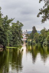 Moving water with colorful reflection of trees on the banks of the river Alva and buildings in Côja in the background, PORTUGAL