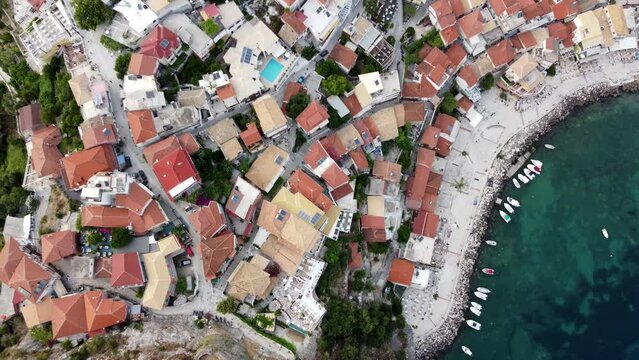 Overhead drone shot of Parga seaside town traditional houses, Greece
