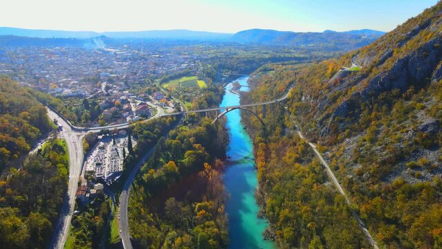 Stunning aerial 4K drone footage of Solkan arch bridge over the Soča river, a majestic stone marvel located in western Slovenia. Filmed in the late autumn on a sunny afternoon.
