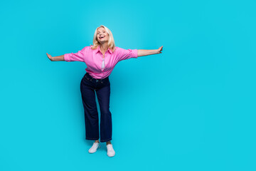 Full body photo of attractive retired woman hands wings have fun wear trendy smart casual clothes isolated on cyan color background