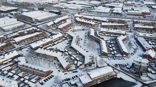 Beautiful aerial of a peaceful small town covered in snow. Filmed in Soest, the Netherlands