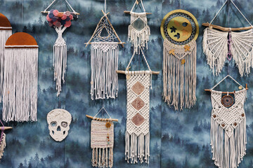 Various feather dream catchers made from the evil eye and souvenir magnets hanging on the walls and...