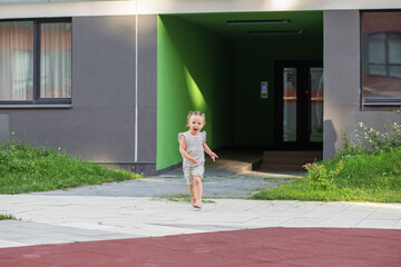 Joyful Toddler Running on a Pathway Outdoors.