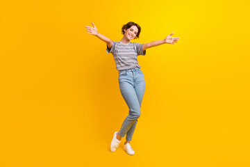 Full length photo of gorgeous positive person raise opened arms welcome invite you isolated on yellow color background