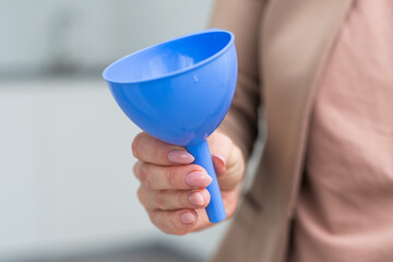 hand holds a funnel isolated on white background