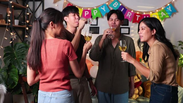 Group of young asian people smiling friends drinking at birthday party toast with beer. food and beverag