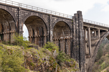 Fototapeta na wymiar A Ponte Ulla, Spain. The viaduct of Gundian, a stone and iron rail bridge over the river Ulla