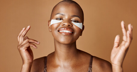 Face, beauty or happy black woman with eye patch for skincare or wellness isolated on brown...
