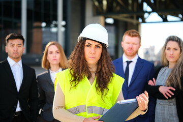 Female architect and business investors serious looking at camera at city business street.