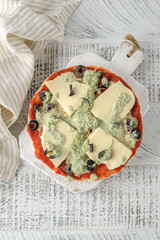 frozen pizza with cheese and olives