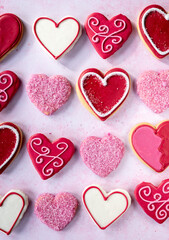heart cookies in a grid with sprinkles and frosting