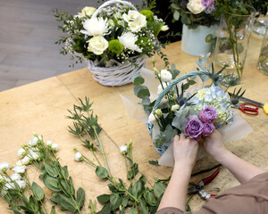Fototapeta na wymiar Florist make composition of roses, hydrangeas and thistles