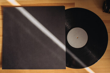 Vinyl record on a wooden table. Vinil album mockup.