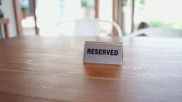 Close up of reserved sign on the cafe table restaurant during daytime