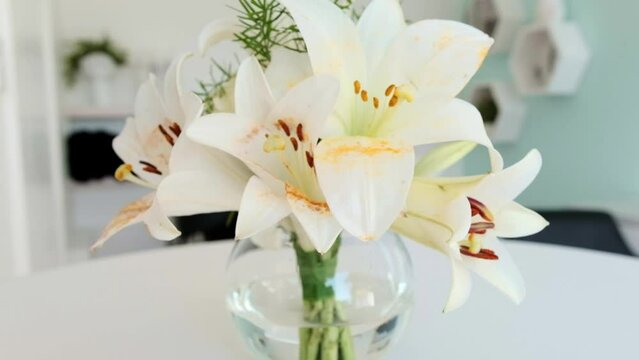 A beautiful white Lily flower arrangement in a glass vase