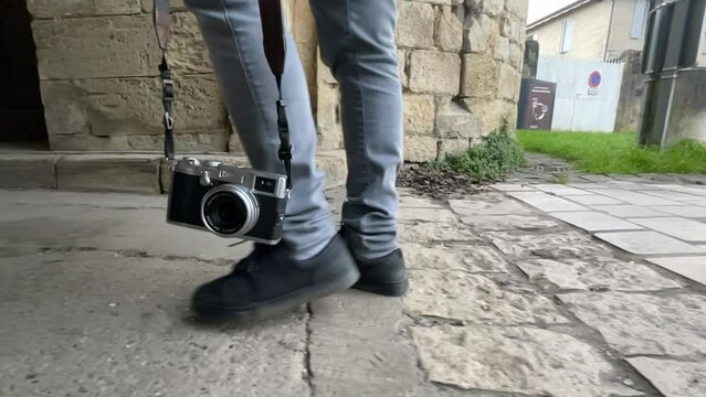 Close Up of man feets walking with a camera on the Streets, Slow motion, High quality 4k footage