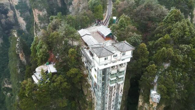 Aerial orbiting shot of the observational Bailong elevator in Zhangjiajie National Park, China