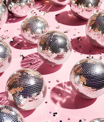 Silver disco balls on pink background