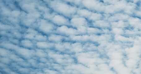 Fototapeta na wymiar Small clouds on the blue sky, abstraction, background, surface movement.