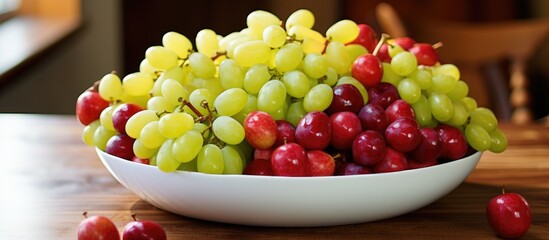 The sight of a bowl filled with a colorful assortment of red apples and green grapes is enough to make anyone's mouth water. 