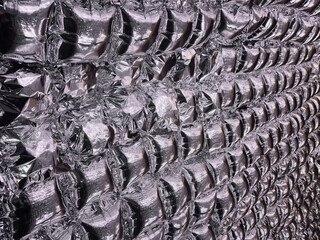 A wall made of inflatable foil squares, a close-up of an inflatable foil wall