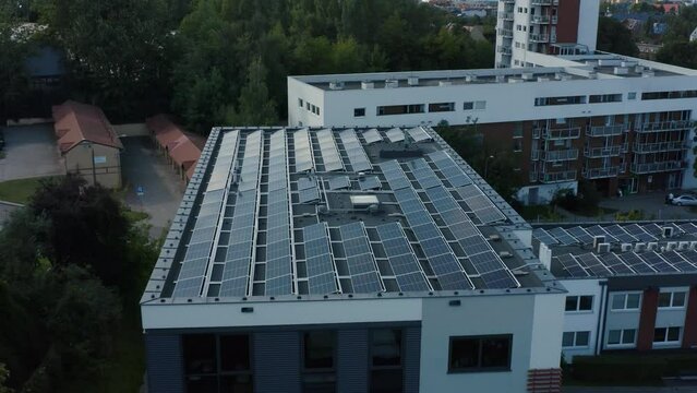 Drone shot solar panels photovoltaic modules installed flat roof office building