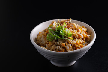 Japanese fried rice yakimeshi isolated in black background - 718097286