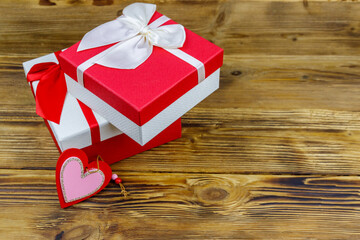 Gift boxes and red heart on a wooden background. Valentine's Day concept