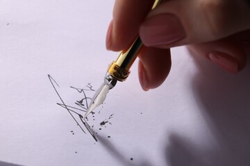 Woman signing on sheet of paper with fountain pen, closeup