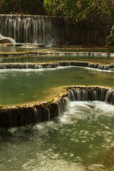 Cascading pools at Kuang Xi Waterfall near Luang Prabang, Laos - Beautiful turquoise blue waterfalls in Asia.