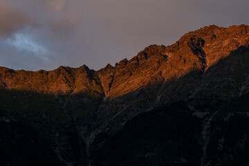 Fototapeta na wymiar Mountain rocky face in sunset in the Alps